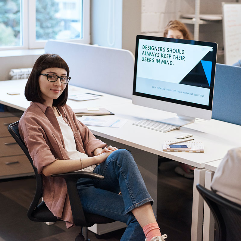 Designer working on a brand layout at a London studio desk fot. PEXELS