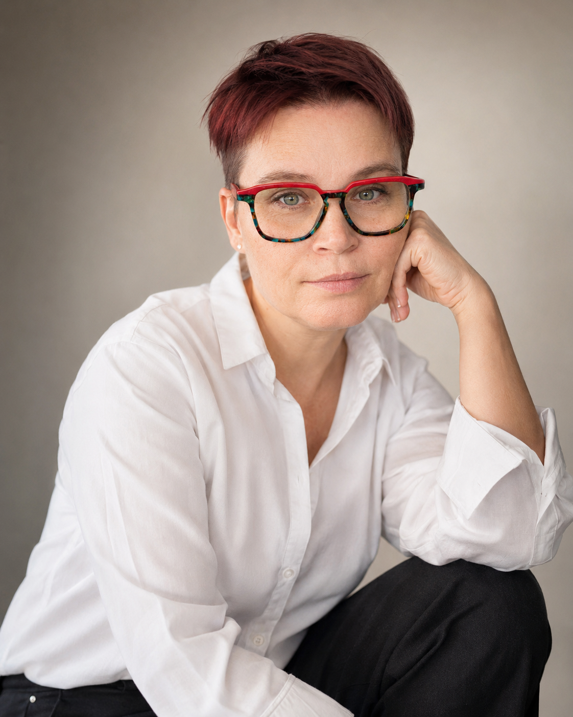 Magdalena Wilicka, founder and creative director of Creative Lab – brand strategist and designer in a white shirt and colourful glasses, editorial studio portrait