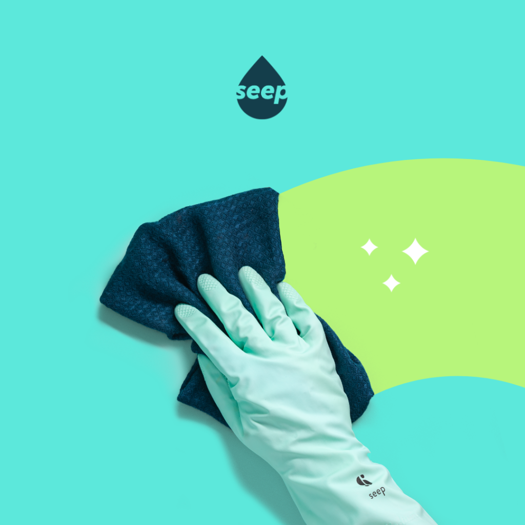 Gloved hand wiping down a bright teal surface with an eco cleaning cloth in a new brand identity for social media and presentations